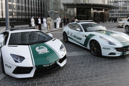 A picture taken on April 25, 2013 shows Lamborghini (L) and Ferrari police vehicles at the foot of the Burj Khalifa tower in the Gulf emirate of Dubai. Two weeks after introducing the Lamborghini police car, Dubai Police has introduced a Ferrari to the fleet, to further strengthen the "image of luxury and prosperity" of the emirate. AFP  PHOTO /  KARIM SAHIB        (Photo credit should read KARIM SAHIB/AFP/Getty Images)