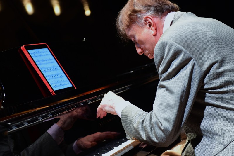 Hungarian pianist Tamas Vasary plays from a tablet with a sheet of a classical music in the concert hall of Budapest Music Center. (Attila Kisbenedek/AFP/Getty Images)