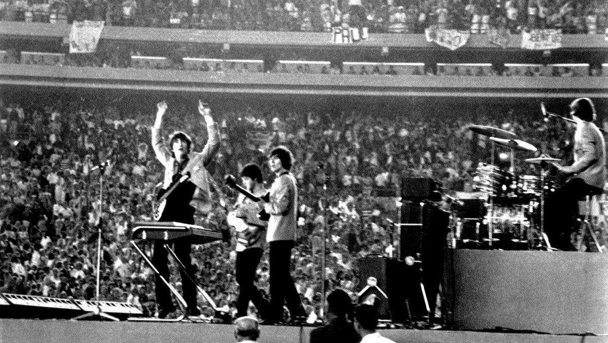 The Beatles perform at Shea Stadium, New York on 15th August 1965. (Photo by Michael Ochs Archives/Getty Images)