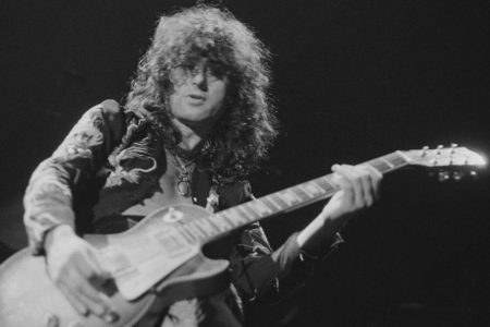 Guitarist Jimmy Page performing with British heavy rock group Led Zeppelin, at Earl's Court, London, May 1975. The band were initially booked to play three nights at the venue, from 23rd to 25th May, but due to public demand, two more concerts were later added, for 17th and 18th May. Total ticket sales were 85,000. (Photo by Michael Putland/Getty Images)