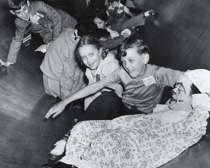 (Original Caption) New York, NY: Children and clown in Coney Island Tunnel of Fun. Photograph 1930's.