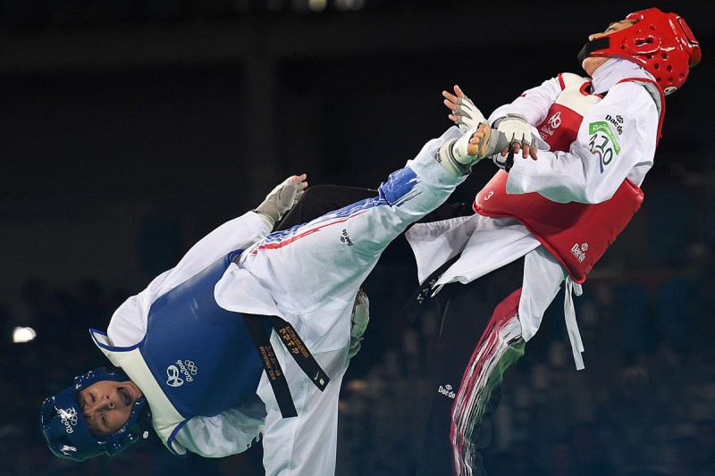 TOPSHOT - Thailand's Phannapa Harnsujin (L) competes against Iran's Kimia Alizadeh Zenoorin during their womens taekwondo repechage bout in the -57kg category as part of the Rio 2016 Olympic Games, on August 18, 2016, at the Carioca Arena 3, in Rio de Janeiro. / AFP / Kirill KUDRYAVTSEV (Photo credit should read KIRILL KUDRYAVTSEV/AFP/Getty Images)