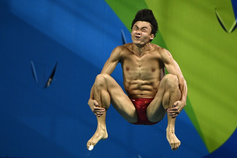 TOPSHOT - China's Cao Yuan competes in the Men's 3m Springboard final during the diving event at the Rio 2016 Olympic Games at the Maria Lenk Aquatics Stadium in Rio de Janeiro on August 15, 2016. / AFP / Martin BUREAU (Photo credit should read MARTIN BUREAU/AFP/Getty Images)