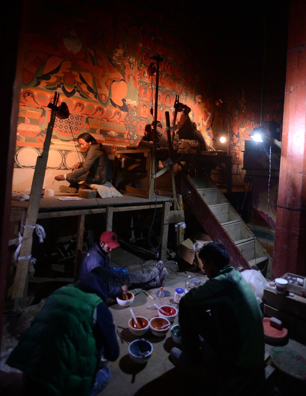 In this photograph taken on June 15, 2016, Nepalese artists restore sacred murals in a monastry in Lo Manthang in Upper Mustang. Deep in the heart of a medieval monastery in Nepal's remote Upper Mustang region, the battle to restore sacred murals and preserve traditional Tibetan Buddhist culture is in full swing. / AFP / PRAKASH MATHEMA / To go with 'Nepal-Tibet-Buddhism-Architecture-Painting' FEATURE by Ammu Kannampilly (Photo credit should read PRAKASH MATHEMA/AFP/Getty Images)