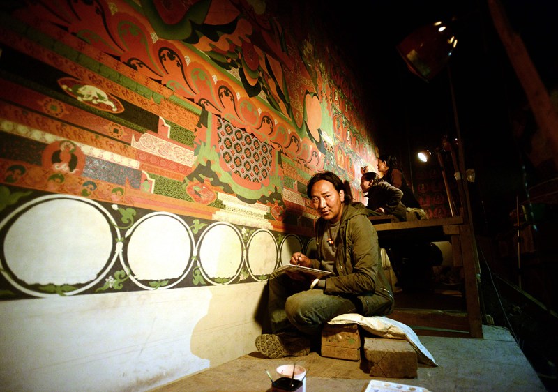 In this photograph taken on June 15, 2016, Nepalese artist Tsewang Jigme looks up during an interview with AFP in Lo Manthang in Upper Mustang. Deep in the heart of a medieval monastery in Nepal's remote Upper Mustang region, the battle to restore sacred murals and preserve traditional Tibetan Buddhist culture is in full swing. / AFP / PRAKASH MATHEMA / To go with 'Nepal-Tibet-Buddhism-Architecture-Painting' FEATURE by Ammu Kannampilly (Photo credit should read PRAKASH MATHEMA/AFP/Getty Images)