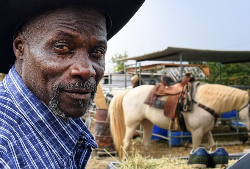 Ivory McCloud poses for a photo with his horse, Diamond, at his stable in the backyard of a home in Compton, Calif., on Sunday, Aug. 7, 2016. "I've got 40 years in this, man," the 56-year-old horseman says. "My dad was a cowboy. I'm a cowboy. I grew up in Compton. I live in Compton and I've been training horses since I was a kid." (AP Photo/Richard Vogel)