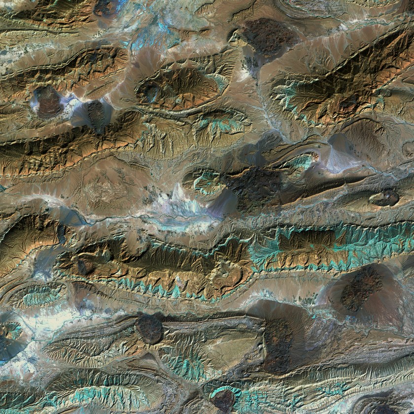 The patterns and colors in the Zagros Mountains of Iran are interesting enough. For example, the infrared view provides a patina-like outline to the mountains. But something more happened to this unique landscape. Interrupting the mountain patterns are irregular dark patches called salt glaciers. What began as salt domes buried under the rock pushed up through the Earth, squeezing to the surface like toothpaste.(USGS/NASA)