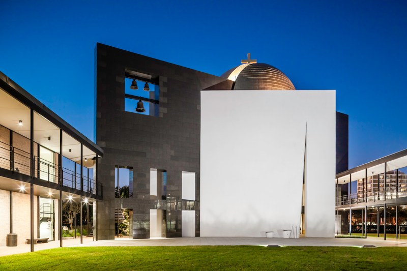 A blue hour photograph of the Chapel of St. Basil, design by renowned architect Philip Johnson, located on the University of St. Thomas Campus in Houston, Texas, USA. The chapel is well know, not only because it's a Philip Johnson design, but also because it incorporate three geometric forms: a cube, a circle and a linear plane.