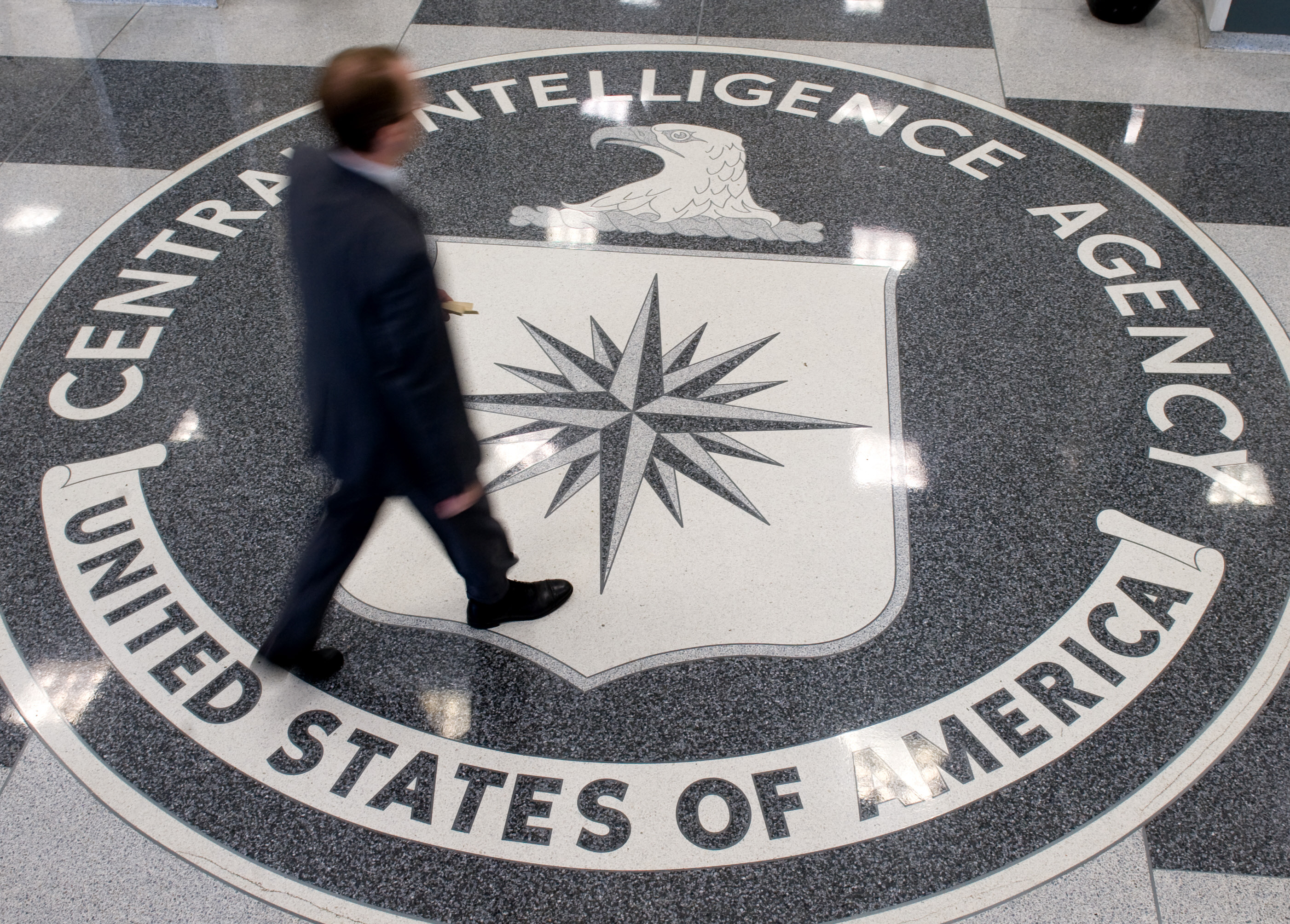 A man crosses the Central Intelligence Agency (CIA) logo in the lobby of CIA Headquarters in Langley, Virginia, on August 14, 2008. (Saul Loeb/AFP/Getty Images)