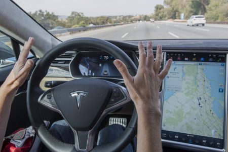 A member of the media test drives a Tesla Motors Inc. Model S car equipped with Autopilot in Palo Alto, California, U.S., on Wednesday, Oct. 14, 2015. (David Paul Morris/Bloomberg via Getty Images)