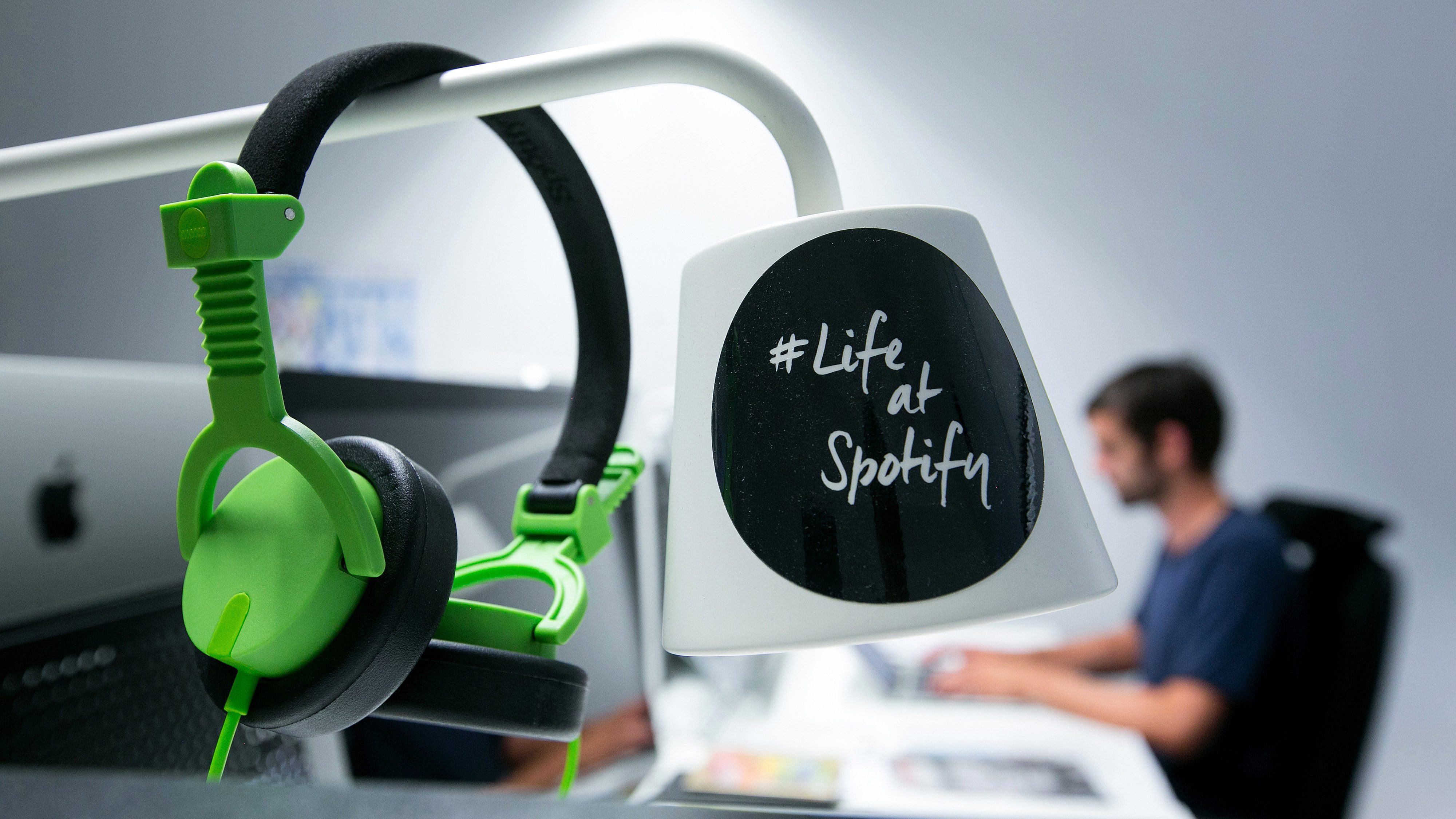 A pair of audio headphones hang from a lamp shade inside the offices music streaming company Spotify Ltd. (Krisztian Bocsi/Bloomberg via Getty Images)