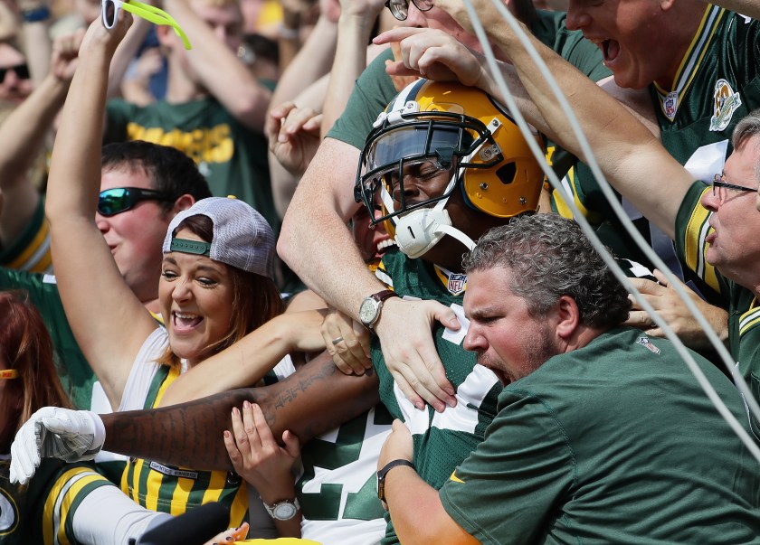 Davante Adams #17 of the Green Bay Packers is grabbed by fans after a "Lambeau Leap" following his touchdown catch in the first quarter against the Detroit Lions at Lambeau Field on September 25, 2016 in Green Bay, Wisconsin. (Jonathan Daniel/Getty Images)