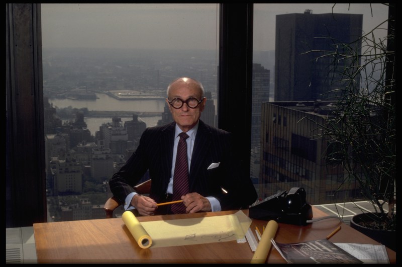 Philip Johnson, known for his architectural achievements, at his desk in his New York City office. (Photo by Corbis/VCG via Getty Images)