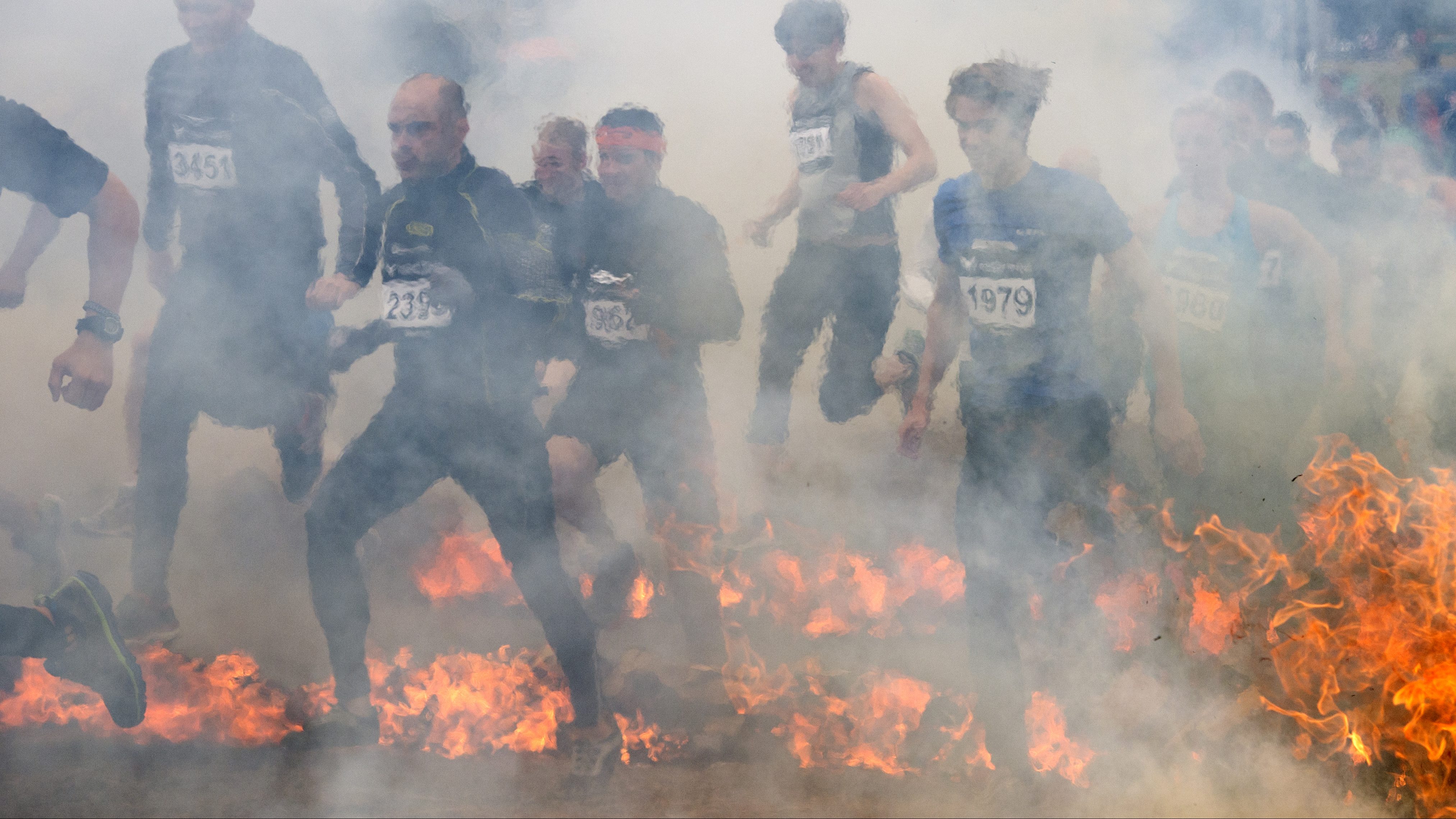 People compete during the fire obstacle part of the Tough Viking race on September 1, 2013 in Stockholm. (Jonathan Nackstrand/AFP/Getty Images)