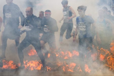 People compete during the fire obstacle part of the Tough Viking race on September 1, 2013 in Stockholm. (Jonathan Nackstrand/AFP/Getty Images)