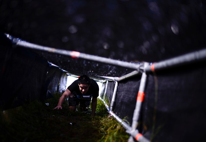 People compete in the Tough Viking race on September 1, 2013 in Stockholm. The course of the Tough Viking race consists of 12 kilometers filled with 15 brutal obstacles (barbed wire, mud, ice, water, tunnels, electricity, fire, climbing, etc.) designed by specialists in the Swedish Armed Forces. AFP PHOTO/JONATHAN NACKSTRAND (Photo credit should read JONATHAN NACKSTRAND/AFP/Getty Images)