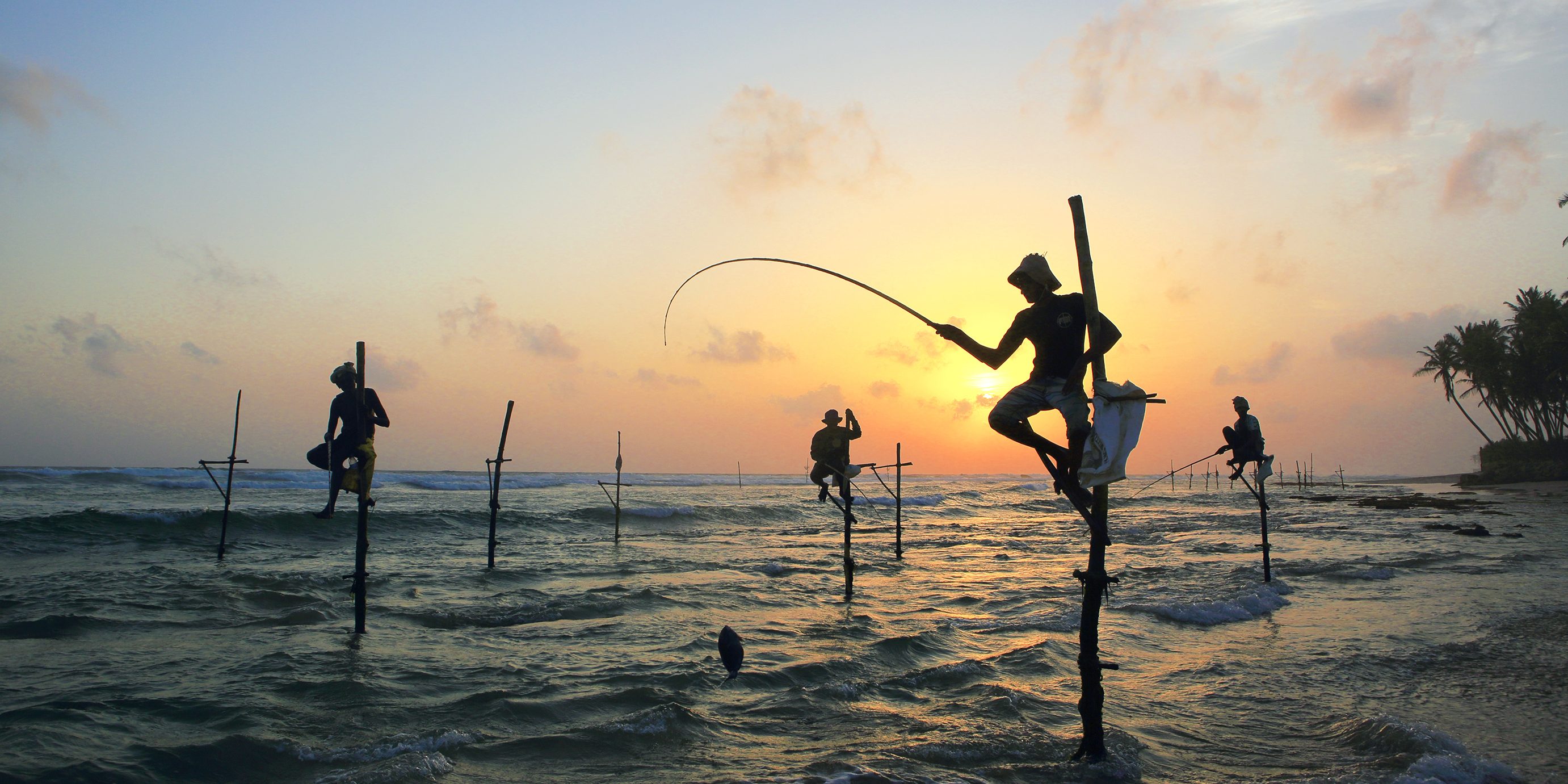 Sri Lankan stilt fishermen at sunset on the south coast. (Paul Kennedy/Lonely Planet Images/ Getty Images)