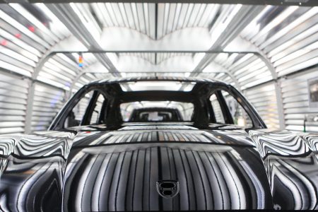 Painted chassis of Porsche Macan sport-utility vehicles (SUV) pass through the paint shop inside the newly expanded Porsche AG factory in Leipzig, Germany, on Wednesday, Feb. 5, 2014. Porsche AG Chief Executive Officer Matthias Mueller said the high-end automaker will exceed 200,000 in annual deliveries in 2015, three years earlier than first targeted, on demand for the Macan compact sport-utility vehicle going on sale later this year. (Krisztian Bocsi/Bloomberg via Getty Images)