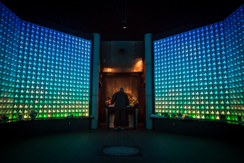 Koukokuji temple head priest Yajima Taijun demonstrates a prayer ritual inside the Ruriden columbarium as glass Buddha alters are lit up on April 6, 2015 in Tokyo, Japan. The Ruriden, operated by the Koukokuji buddhist temple, took two years to build and houses 2046 futuristic alters with glass buddha statues that correspond to drawers storing the ashes of the deceased. An IC card allows the owner of the alter to access the building and lights up the corresponding statue. The ashes are stored for 33 years before being buried below the Ruriden, currently 600 alters are in use and another 300 are reserved. (Photo by Chris McGrath/Getty Images)