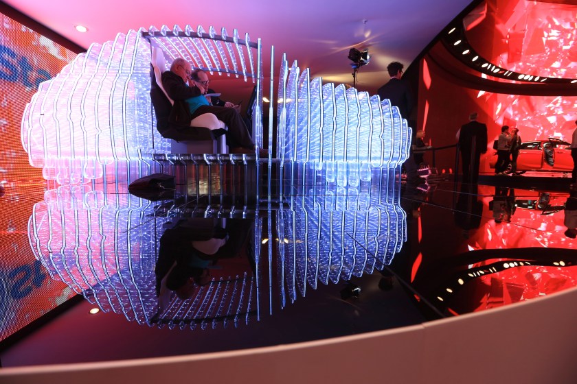 Visitors sit inside a light installation in the shape of a car on the Opel OnStar display, Adam Opel AG's in-car connected app technology, on the company's stand during previews to IAA Frankfurt Motor Show in Frankfurt, Germany, on Tuesday, Sept. 15, 2015. (Krisztian Bocsi/Bloomberg via Getty Images)