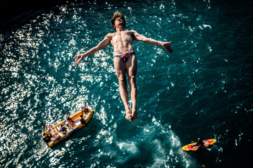 POLIGNANO A MARE, ITALY - AUGUST 26: (EDITORIAL USE ONLY) In this handout image provided by Red Bull, Gary Hunt of the UK dives from the 27 metre platform during the first training session for the fifth stop of the Red Bull Cliff Diving World Series, Polignano a Mare, Italy. (Photo by Dean Treml/Red Bull via Getty Images)