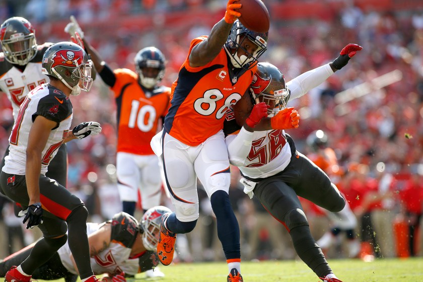 Wide receiver Demaryius Thomas #88 of the Denver Broncos fends off middle linebacker Kwon Alexander #58 of the Tampa Bay Buccaneers as crosses the goal line for a touchdown during the first quarter of an NFL game on October 2, 2016 at Raymond James Stadium in Tampa, Florida. (Brian Blanco/Getty Images)