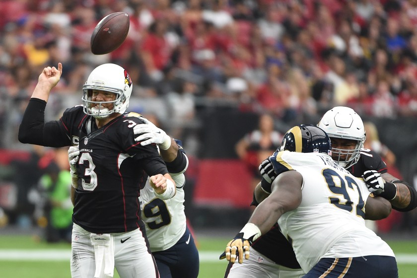 Quarterback Carson Palmer #3 of the Arizona Cardinals is hit by defensive tackle Aaron Donald #99 of the Los Angeles Rams during the second half of the NFL game at University of Phoenix Stadium on October 2, 2016 in Glendale, Arizona. (Norm Hall/Getty Images)