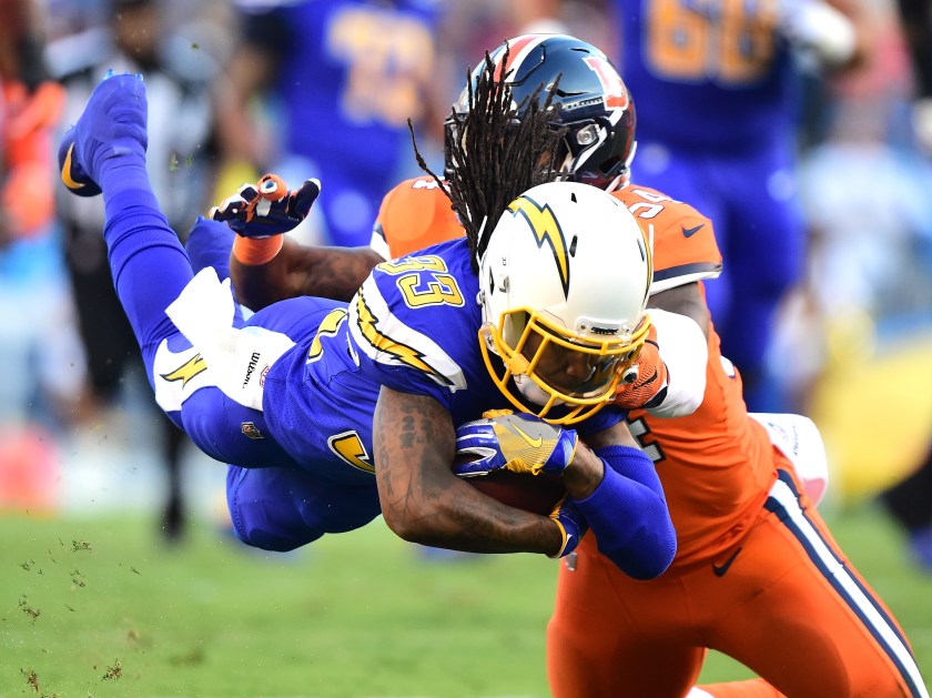 Dexter McCluster #33 of the San Diego Chargers dives with the ball as he is tackle by Brandon Marshall #54 of the Denver Broncos during the first quarter at Qualcomm Stadium on October 13, 2016 in San Diego, California. (Harry How/Getty Images)