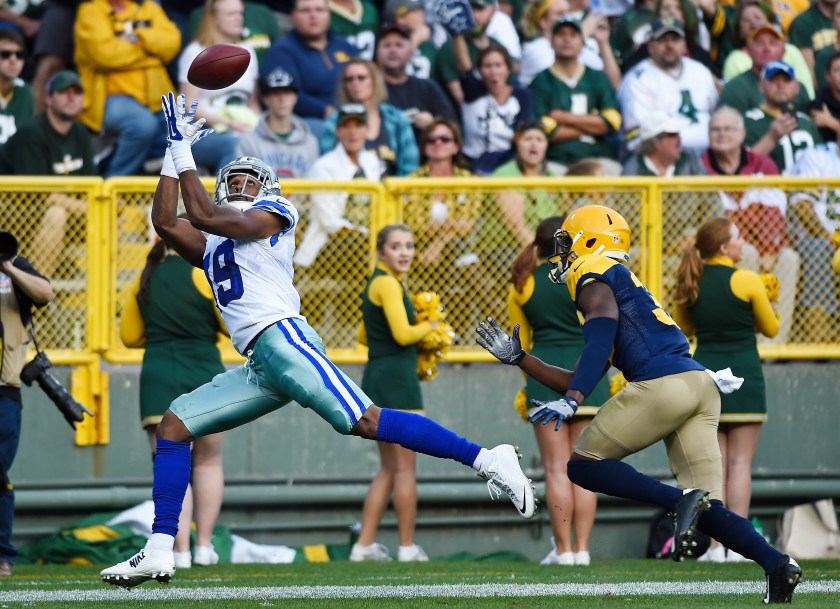 Brice Butler #19 of the Dallas Cowboys catches a touchdown pass under pressure from Micah Hyde #33 of the Green Bay Packers during the second quarter at Lambeau Field on October 16, 2016 in Green Bay, Wisconsin. (Hannah Foslien/Getty Images)