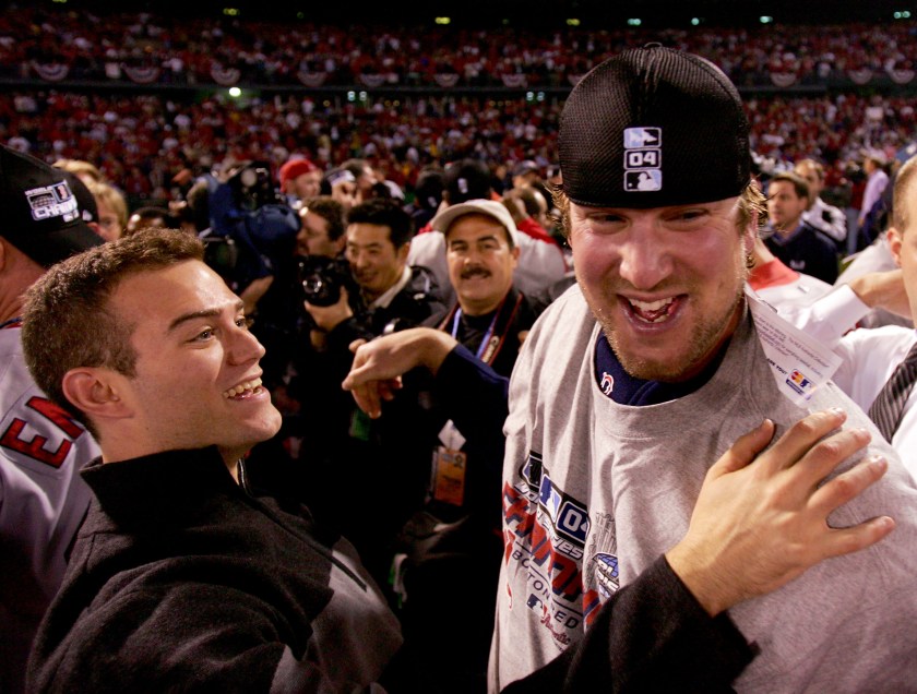 Derek Lowe #32 and general manager Theo Epstein of the Boston Red Sox celebrate after defeating the St. Louis Cardinals 3-0 in game four of the World Series on October 27, 2004 at Busch Stadium in St. Louis, Missouri. (Jed Jacobsohn/Getty Images)