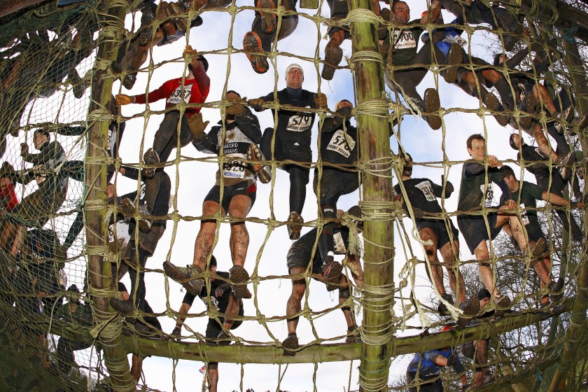 A group climbing the 40-foot ladder at Assault Course, an endurance obstacle course in Perton, England. (Bob Martin/Sports Illustrated/Getty Images)