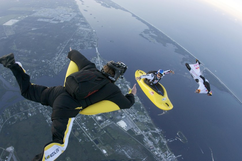 Mike Swanson is in a camera wing suit shooting two Red Cameras capturing 3D images of Miles Daisher in his Skyak while Andy Farrington flies a wing suit past Miles in Sebastian, Florida. Danger man Miles Daisher casts a bizarre image paddling across the sky - 13,000 feet up in a kayak. (Eli Thompson / Barcroft Media / Getty Images)