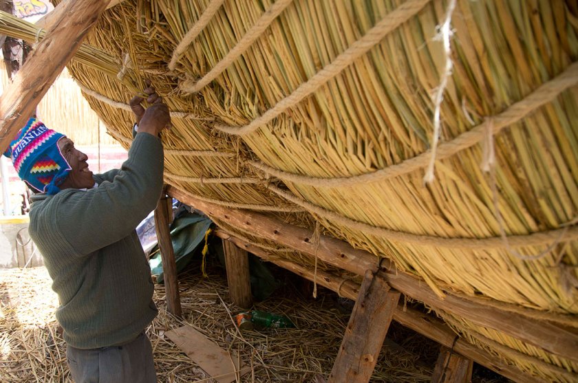 Seventy-one-year-old Juan Limachi, who has been building reed boats since the age of seven using the technology inherited from his Aymara ancestors, works on the "Viracocha III," in La Paz, Bolivia, Wednesday, Oct. 19, 2016. (Juan Karita/AP)