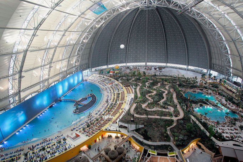 BRAND, GERMANY - JANUARY 8: Visitors flock to the Tropical Islands Resort, including "South Sea" (L) and a laguna (R), complete with tropical tress, white sand and Polynesian restaurants, January 8, 2005 in Brand, Germany. The indoor resort is housed in a building originally intended as a hangar for airships, though that project went bust and Malaysian businessman Colin Au bought the building and turned it into a tropical getaway located about 40 miles south of Berlin. (Photo by Sean Gallup/Getty Images)