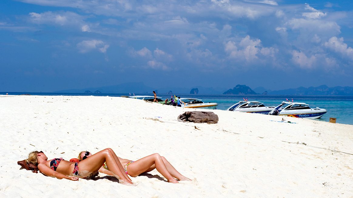 Sunbathers relax on the beach of a paradise island part of Ko Phi Phi islands in the Adaman Sea, Krabi province, Thailand. (Lucas Schifres/Getty Images)