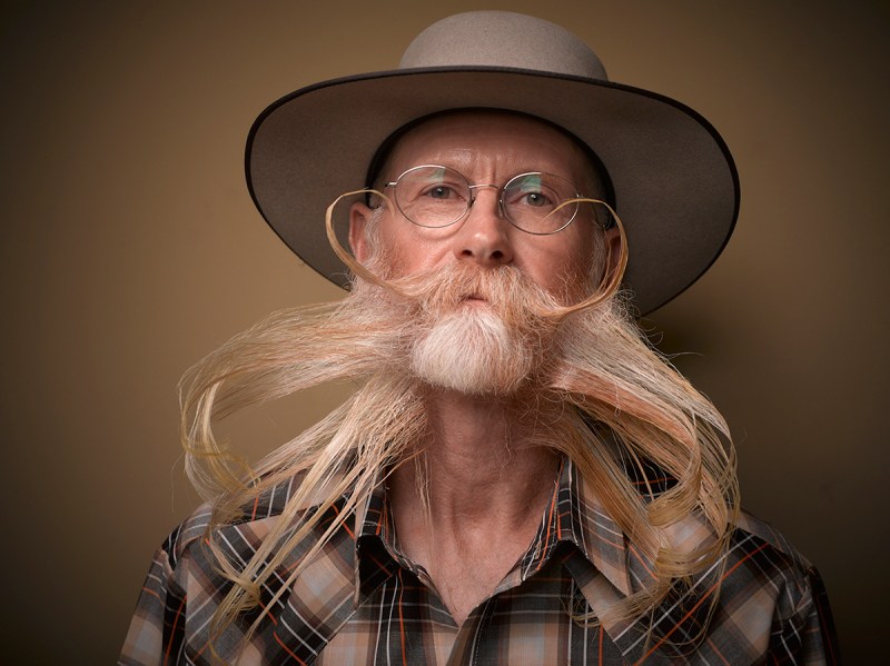 PIC BY GREG ANDERSON / CATERS NEWS - (PICTURED: A contestant of the beard championship with an extra long beard and moustache.) - Gents from around the world descended on Nashville earlier this month fighting for the title of best beard in the National Beard and Moustache Championship. The annual competition covers 17 categories in which the men can compete, ranging from freestyle, to natural, to facial hair inspired by icons such as Dali and the Musketeers. With the competition as stiff as the waxed moustaches, competitors had to go beard to beard to decide whose facial fuzz was the most fan-TASH-tic. Competitors were judged on their overall appearance, style and personality, with judges also considering originality and creativity in the freestyle categories. Contestants certainly rose to the challenge with perfectly curled beards and also more outrageous statement styles, such as a Tim Burton themed beard, and a beard styled to look like a beak. - SEE CATERS COPY