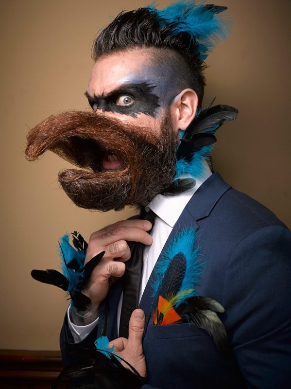 PIC BY GREG ANDERSON / CATERS NEWS - (PICTURED: A contestant with a beard shaped like a beak.) - Gents from around the world descended on Nashville earlier this month fighting for the title of best beard in the National Beard and Moustache Championship. The annual competition covers 17 categories in which the men can compete, ranging from freestyle, to natural, to facial hair inspired by icons such as Dali and the Musketeers. With the competition as stiff as the waxed moustaches, competitors had to go beard to beard to decide whose facial fuzz was the most fan-TASH-tic. Competitors were judged on their overall appearance, style and personality, with judges also considering originality and creativity in the freestyle categories. Contestants certainly rose to the challenge with perfectly curled beards and also more outrageous statement styles, such as a Tim Burton themed beard, and a beard styled to look like a beak. - SEE CATERS COPY