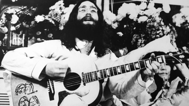 CANADA - 1969: John Lennon with beard and long hair singing and playing guitar in 1969 in Canada. (Photo by Keystone-France/Gamma-Rapho via Getty Images)