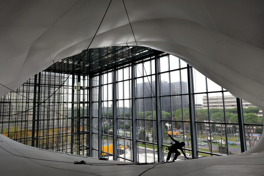 A man works on the structure of the new convention center named "The cloud" ("La Nuvola" in Italian) designed by Italian architect Massimiliano Fuksas on October 19, 2016 in the Eur business district in Rome. (Alberto Pizzoli/AFP)