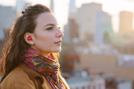 Pilot, the red stylish earbud, could be the world's first translating wearable device (Courtesy Waverly Labs)