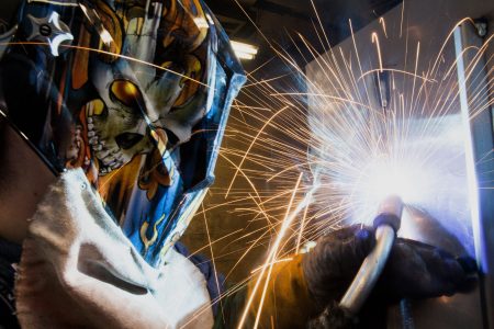 An employee uses a mig welder to create a welding beed on the inside seem of a Pioneer coal stove at the Leisure Line Stove Co. facility in Berwick, Pennsylvania, U.S., on Friday, Aug. 30, 2013. (Ty Wright/Bloomberg via Getty Images)