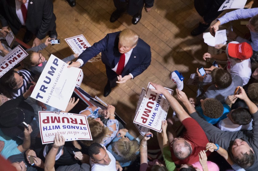 Republican presidential candidate Donald Trump greets guests after speaking at a campaign rally at Burlington Memorial Auditorium on October last year. (Scott Olson/Getty Images)