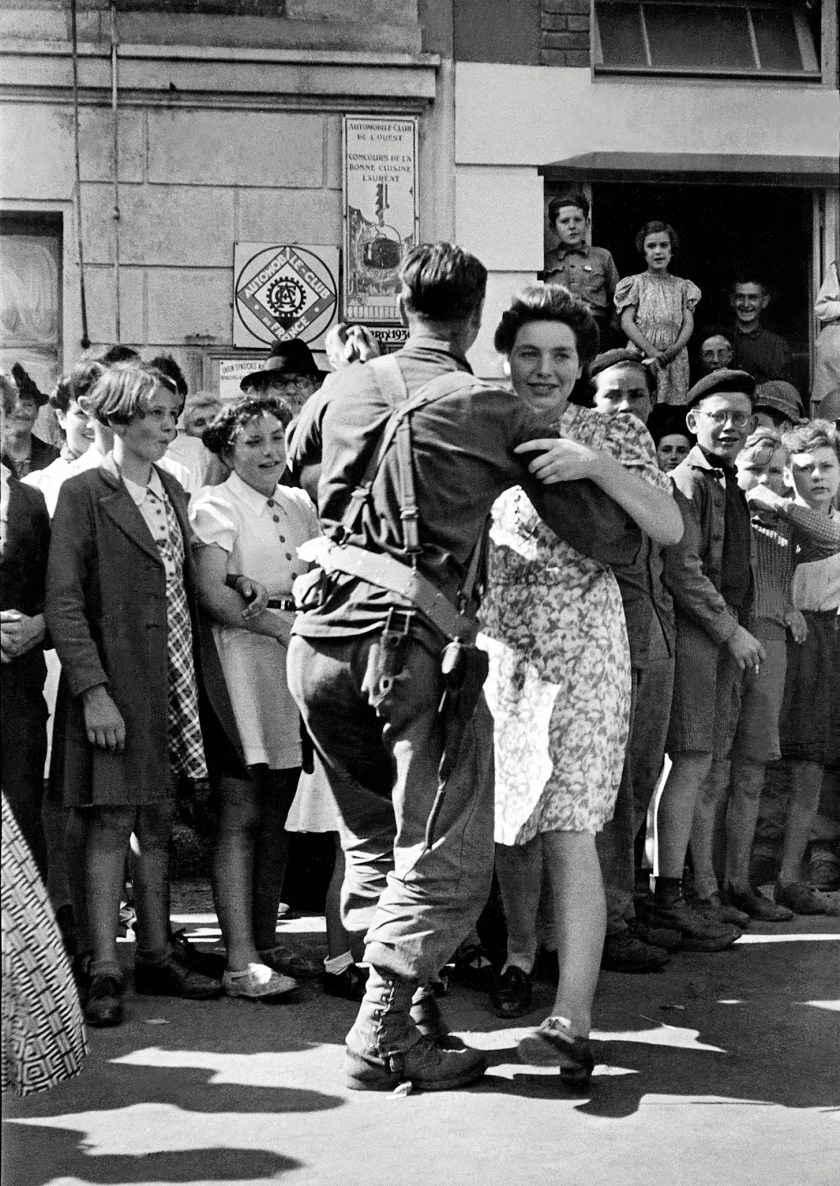 An American GI dances with Marie-Therese Crochu in Saint-Briac-sur-Mer, France, World War II, after the liberation of the town, 15th August 1944. French children Monique Rault and Josette Joly can be seen on the right, Rene Gesse on the left. (Tony Vaccaro/Getty Images)