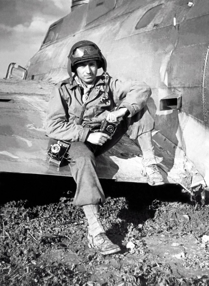 Photographer and GI Tony Vaccaro sits on the wing of a downed B-17 Flying Fortress, Mondorf-Les-Bains, Luxembourg, World War II, September 1944. (Anthony Montana/Tony Vaccaro/Getty Images)