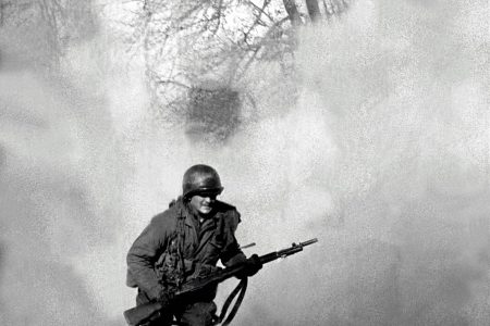 American GI Ivan Parrott is seen running through smoke in no mans land near Neuss, Germany during the Battle for the Rhine, World War II, 1st March 1945. (Tony Vaccaro/Getty Images)