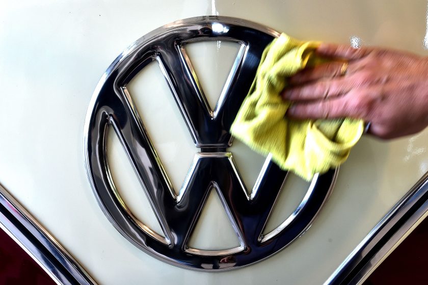 A man cleans the VW logo on a vintage Volkswagen Kombi bus (van, transporter or camper) restored by the "T1 specialist" team, on November 3, 2016 at the garage Nucci in Florence. (Alberto Pizzoli/AFP/Getty Images)