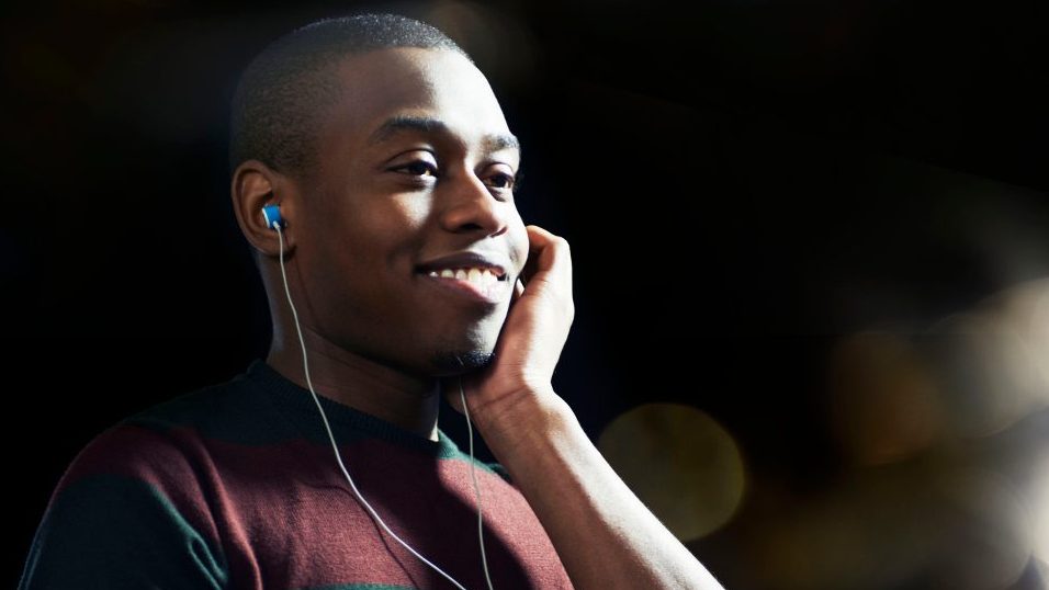 Man smiling with headphones and mobile phone
(Tara Moore)