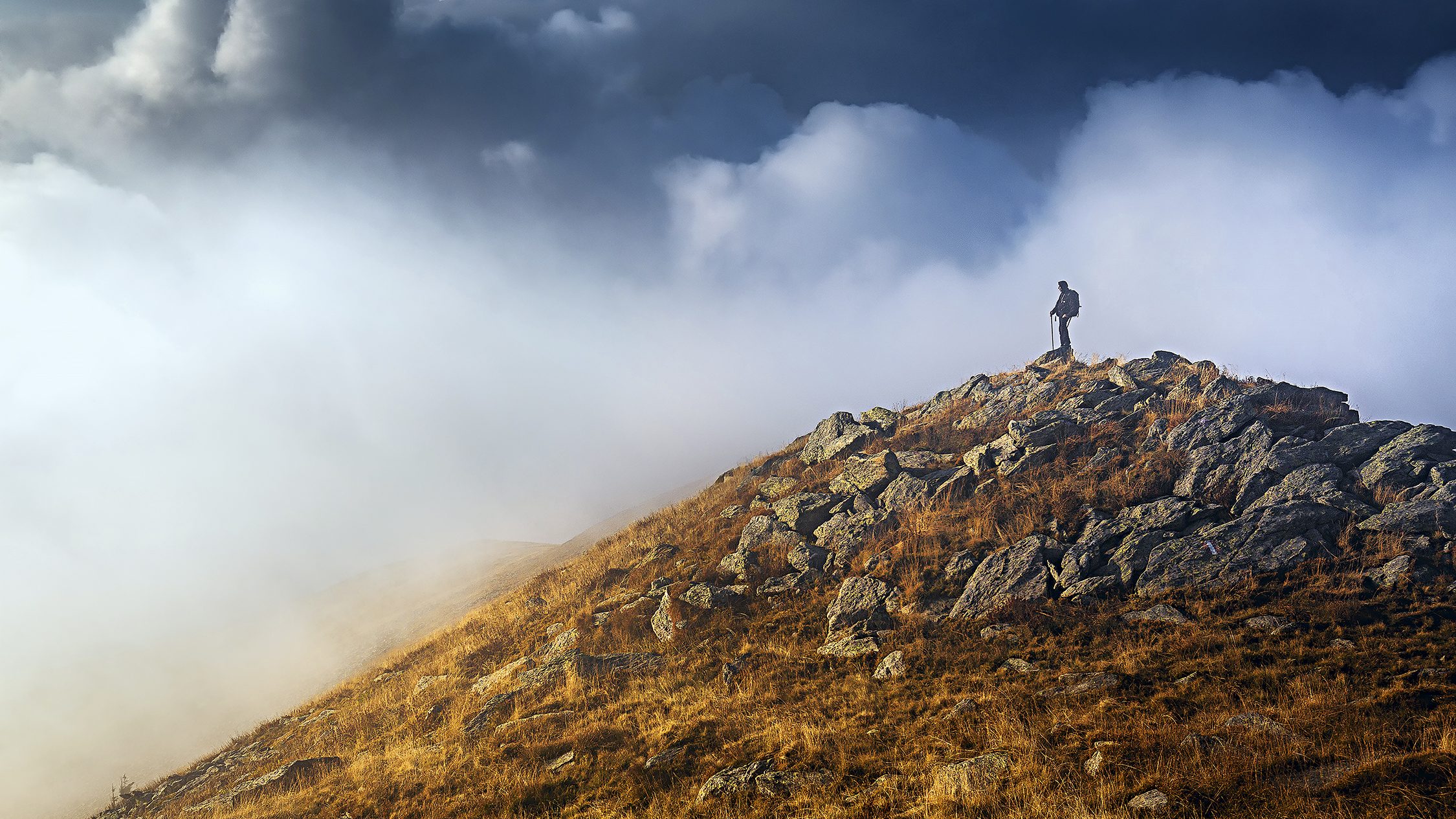 A hiker stands on the peak of Matorac in the Dinaric Alps of central Bosnia and Herzegovina, along a section of the Balkans’ 1,200-mile Via Dinarica trail. (Courtesy National Geographic Traveler)