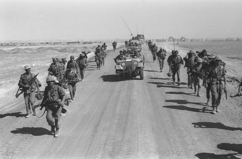 Israeli paratroopers march October 25, 1973 along the Suez-Cairo road on the western bank of the Suez Canal during the Yom Kippur War. Current Israeli Prime Minister Ariel Sharon, then a general in the Israeli army, refused to rule out another surprise attack similar to the one launched by the Arab armies when they struck against Israeli troops in the Sinai Desert and Golan Heights on the holiest day of the Jewish calendar on October 6, 1973. (Ilan Ron/GPO/Getty Images)