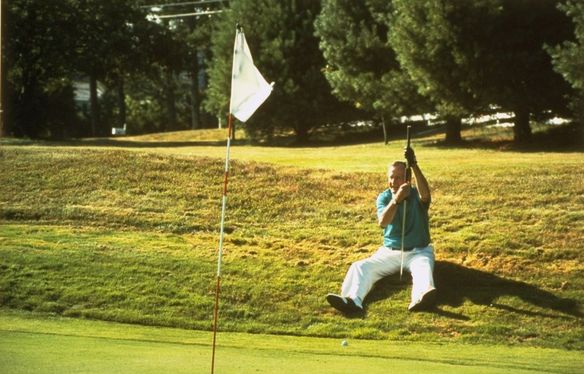 President George Bush laying on ground lining up golf putt. (David Valdez/White House/The LIFE Picture Collection/Getty Images)